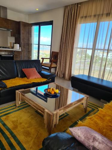 a living room with a couch and a table at Appartement moderne vue sur mer in Essaouira