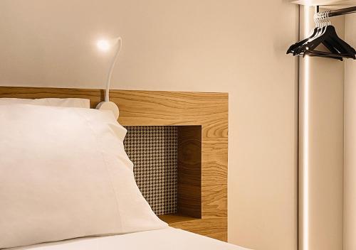 a bedroom with a bed with a headboard and a lamp at Al Pio Luxury Nest in Treviso