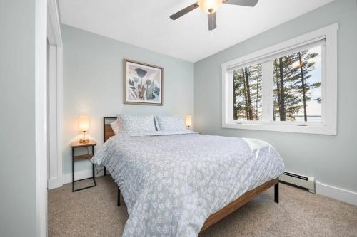 a bedroom with a bed and a window at Long Lake Dream Dogs Welcome in Traverse City
