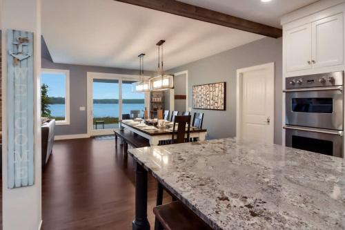 a kitchen and dining room with a large counter top at Bear Feet Retreat in Maple City