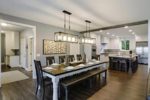 a dining room and kitchen with a table and chairs at Bear Feet Retreat in Maple City