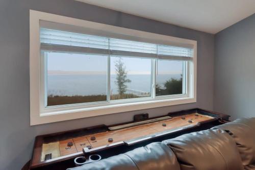 a living room with a couch and a large window at Bear Feet Retreat in Maple City