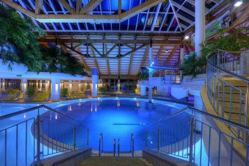 a large swimming pool inside of a building at Ferienwohnung Alpinstar - inklusive Oberstaufen Plus in Oberstaufen