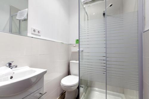 a bathroom with a toilet and a sink and a shower at Gilbert accommodations in London