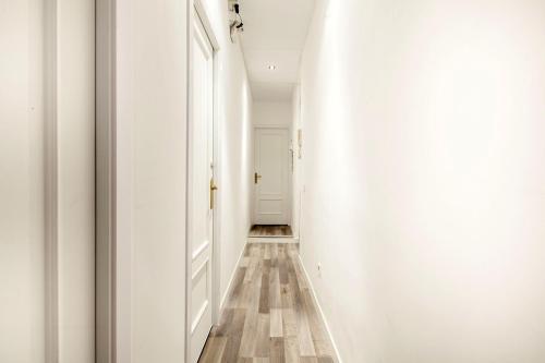 a hallway with white walls and a wooden floor at Gilbert accommodations in London