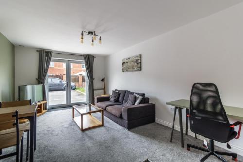 a living room with a couch and a table at 2 Bedroom Flat 1, Glasshoughton in Castleford