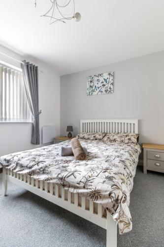 a white bedroom with a bed with a blanket at 2 Bedroom Flat 1, Glasshoughton in Castleford