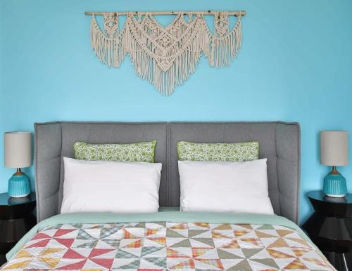 a bedroom with a bed with a heart on the wall at Lakeside PEC: Beautiful Waterfront & Patio in Wellington