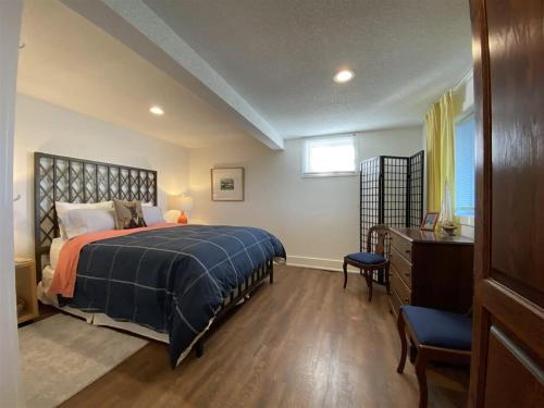 a bedroom with a bed and a dresser and a window at The Verne: Beautiful Waterfront Escape by Picton in Picton
