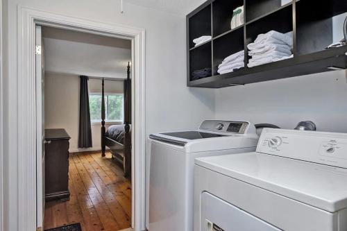 a laundry room with a washer and dryer in it at The Highway House - PEC Waterview Getaway in Wellington