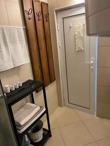 a bathroom with a shower and a glass door at Квартира студия на берегу моря in Byala