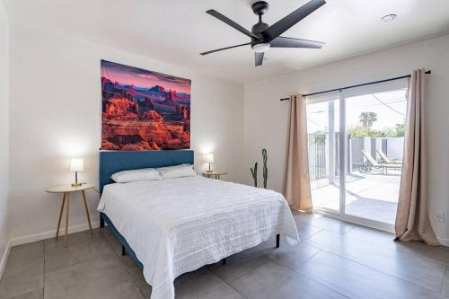 a bedroom with a bed and a painting on the wall at West Tucson Desert Haven - Close to Downtown, Hiking, bikng and more! in Tucson