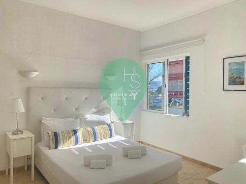 a bedroom with a bed with a balloon on the wall at Yes Centro de Vilamoura Saturno T1 in Quarteira