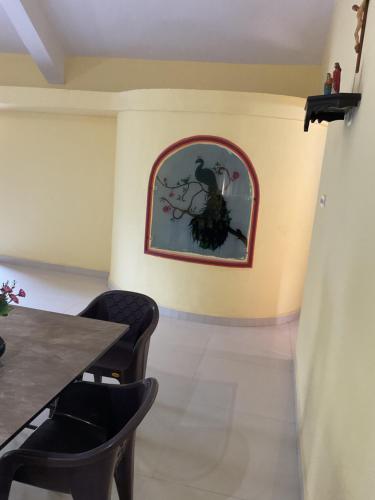 a dining room with a table and chairs at Grace Homestay in Benaulim