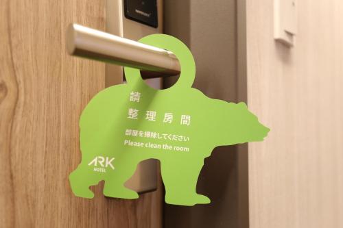 a green door opener with a dog sticker on it at Ark Hotel - Changan Fuxing方舟商業股份有限公司 in Taipei