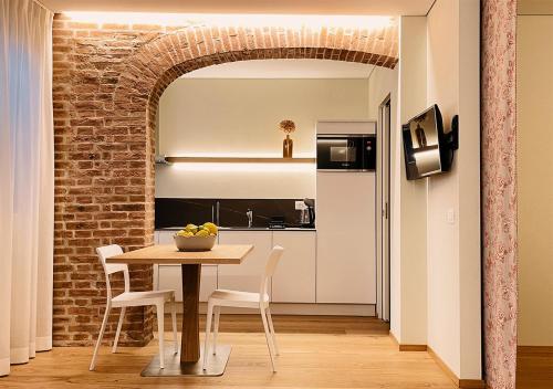 a kitchen and dining room with a table and chairs at Al Pio Luxury Nest in Treviso