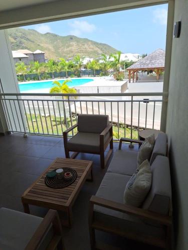 a living room with a couch and a view of a pool at Easy Friendly SXM in Cul de Sac
