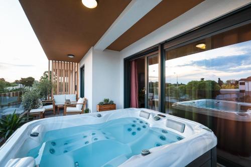 a jacuzzi tub on the balcony of a house at Luma Luxury Apartment with Jacuzzi in Zadar