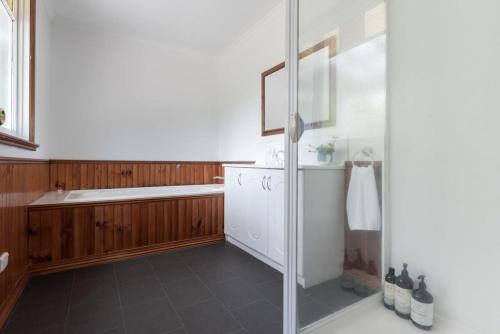 a bathroom with a shower and a sink at Charming Little Home Close To The City w Parking And Wifi in Kings Park