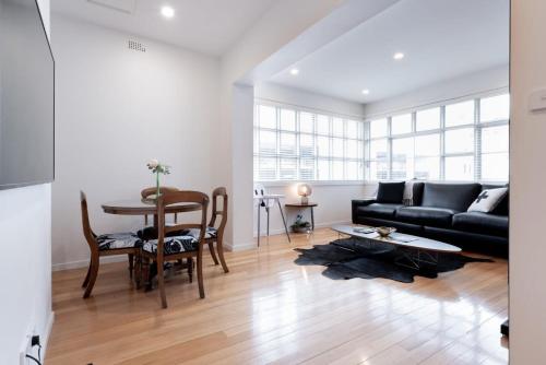 a living room with a couch and a table at Inner City Living in Launceston