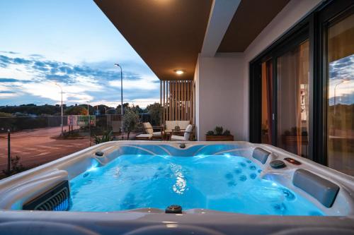 a jacuzzi tub in the middle of a house at Luma Luxury Apartment with Jacuzzi in Zadar