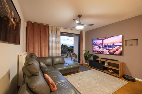 a living room with a couch and a flat screen tv at Luma Luxury Apartment with Jacuzzi in Zadar