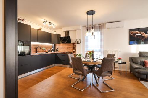 a kitchen and dining room with a table and chairs at Luma Luxury Apartment with Jacuzzi in Zadar