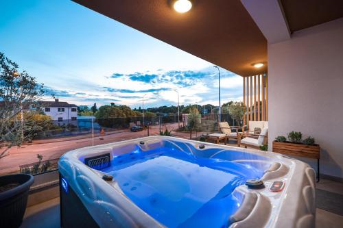 a jacuzzi tub on a balcony with a view at Luma Luxury Apartment with Jacuzzi in Zadar