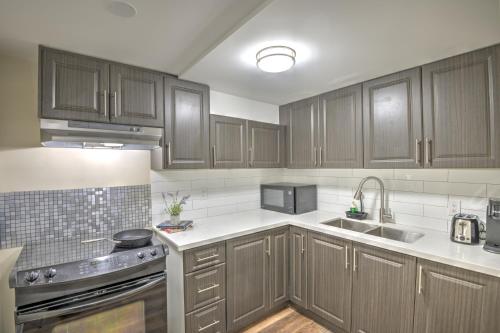 a kitchen with wooden cabinets and stainless steel appliances at Relaxing 3 Bedroom Basement Stay in Mississauga