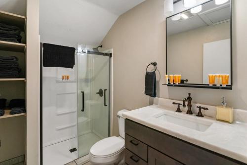 uma casa de banho com um lavatório e um chuveiro em 2 Lakeside Apartment Units in One at Fife Lake Lodge em Fife Lake