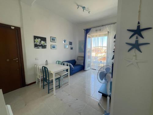 a living room with a table and stars on the wall at A un passo dal mare! in Piombino