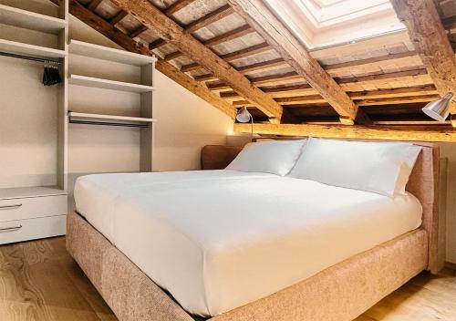 a bedroom with a large white bed in a room at Al Pio Luxury Nest in Treviso