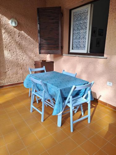 a blue table and chairs in a room at Sardegna Calaverde Villetta in Forte Village