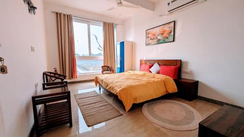 a bedroom with a bed and a window at Ayaansh Resort- Westin Sohna Complex in Sohna