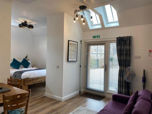 a living room with a bed and a window at Butterfly Cottage in Grantown on Spey