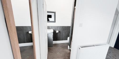 a bathroom with a toilet and a sink at Large Room in Modern House near Nottingham in Nottingham
