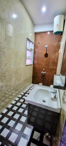 a bathroom with a white sink in a room at Ayaansh Resort- Westin Sohna Complex 1 - 3 - 4- 7 - BHK in Sohna
