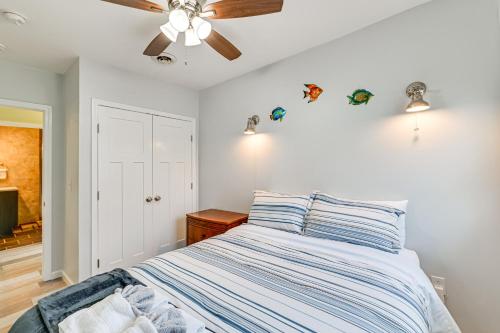 a bedroom with a bed and a ceiling fan at Pet-Friendly Honeoye Cottage Rental Walk to Lake! in Honeoye