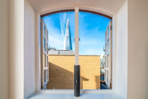 a window with a view of the burj khalifa at TruStay Apartments London Bridge in London