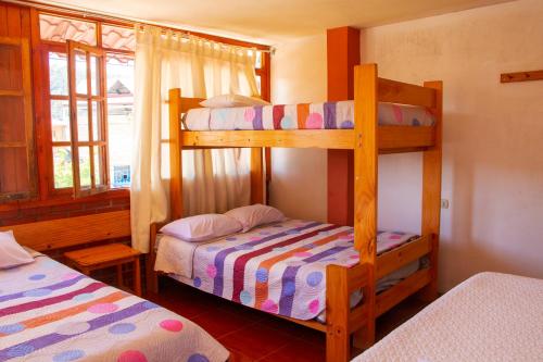 1 Schlafzimmer mit 2 Etagenbetten und einem Fenster in der Unterkunft HOSPEDAJE SCHASCA in Oxapampa