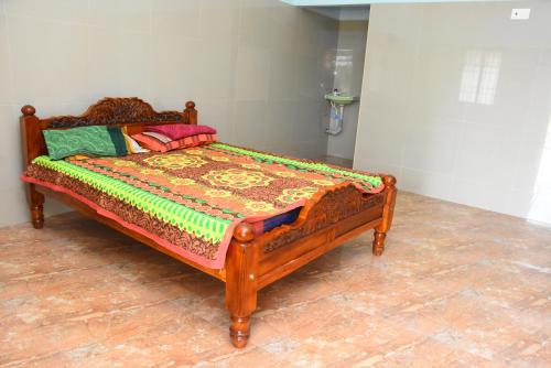 Muthukumaran Palace tesisinde bir odada yatak veya yataklar