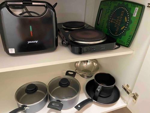 a kitchen counter with pots and pans and a toaster at Monte Carmel in Ribeirão Preto