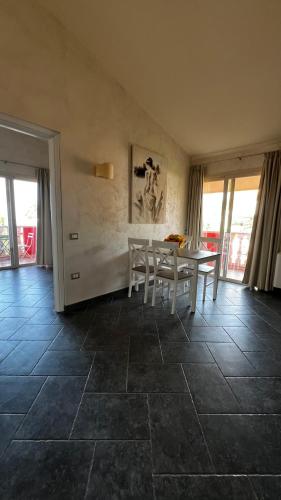 a dining room with a table and chairs on a tile floor at Borgo di Santa Barbara in Santa Domenica