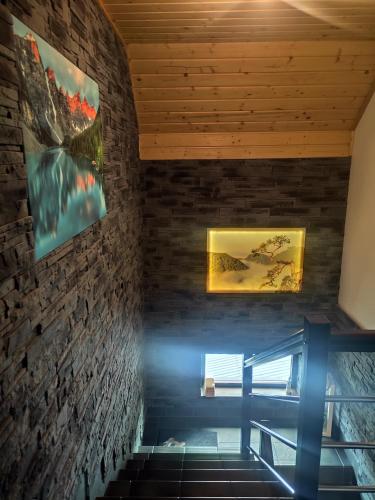 a staircase in a house with paintings on the wall at Pokoje i apartamenty u Sabiny - DOSTĘP DO JACUZZI TYLKO W WYBRANYCH OPCJACH sprawdź poniżej szczegóły rezerwacji in Szczawnica