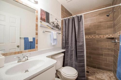 a bathroom with a toilet and a sink and a shower at 34B- Modern studio condo heated pool and dog park in Casa Grande