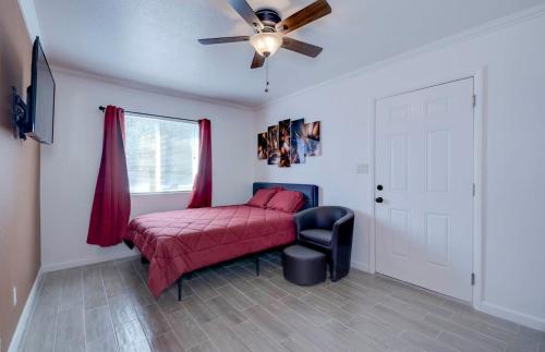 a bedroom with a red bed and a ceiling fan at 37B- Casa Grande Condo full remodel w HEATED POOL in Casa Grande
