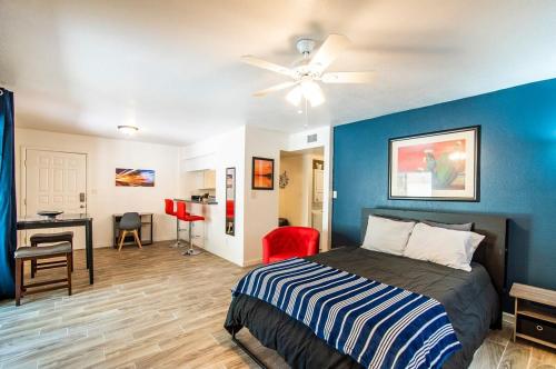 a bedroom with a bed with a blue wall at 41A Modern Large Studio Condo w heated pool in Casa Grande