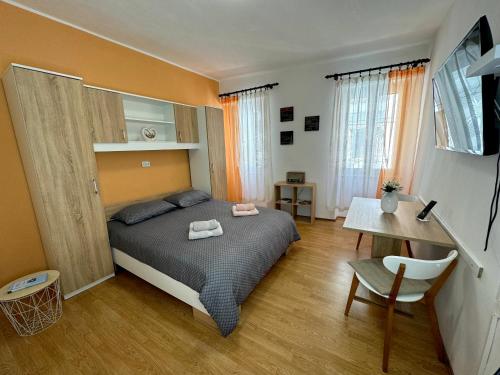 a bedroom with a bed and a desk and a table at Apartment Marija in Vodnjan
