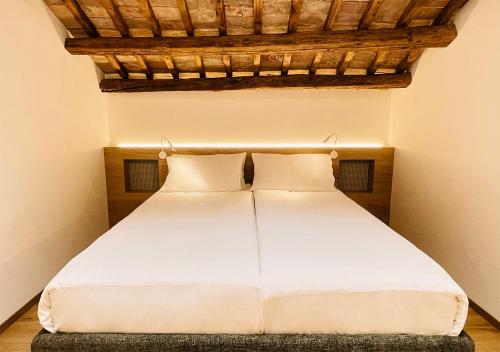 a bedroom with a white bed with two pillows at Al Pio Luxury Nest in Treviso