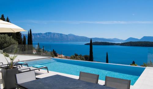 a swimming pool with a view of a lake at Apaggio Villas in Nydri